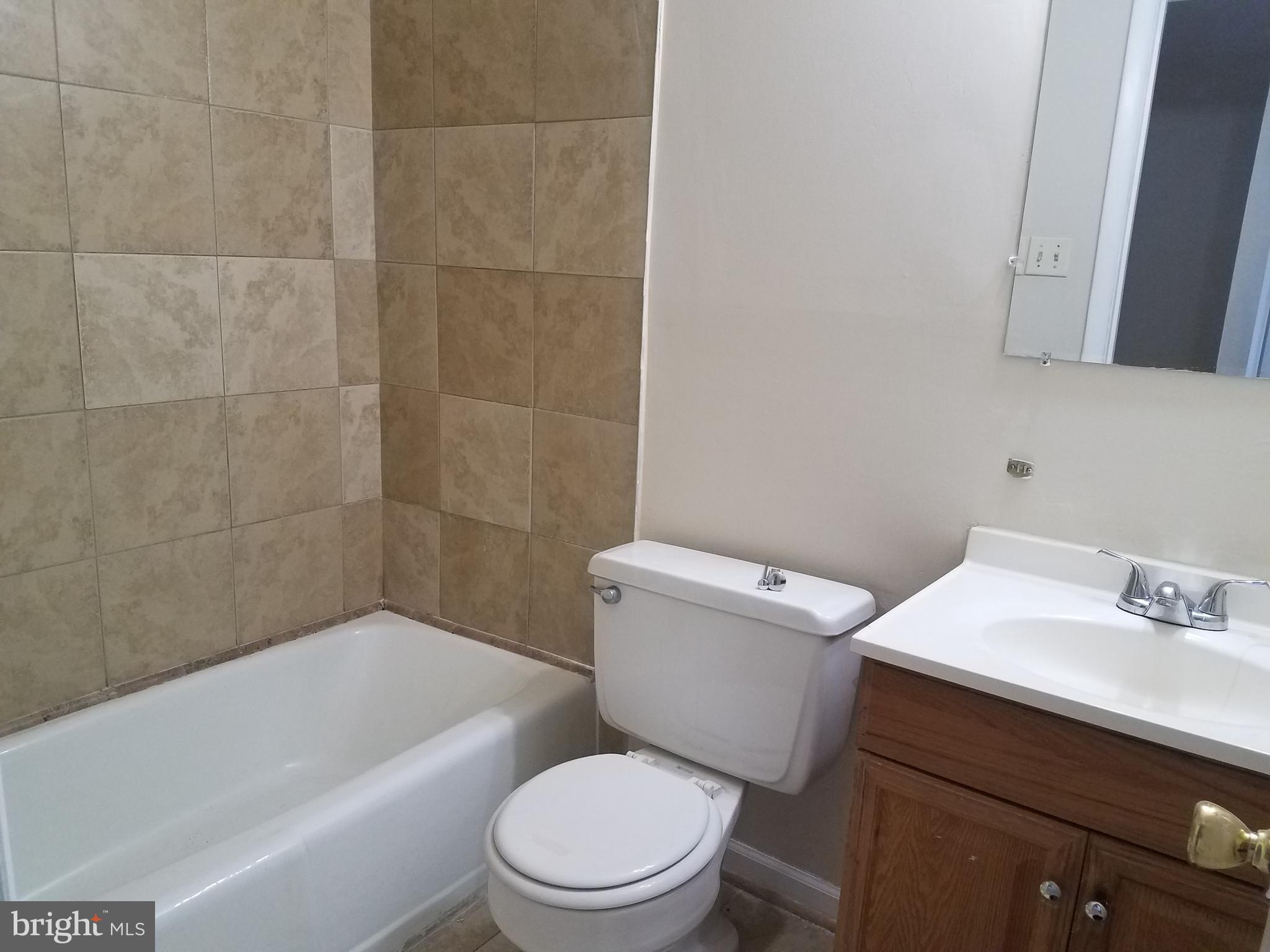 8024 Sandy Spring Road Laurel, MD 20707 - Photo 14 of 21 a bathroom with a sink a toilet and bathtub