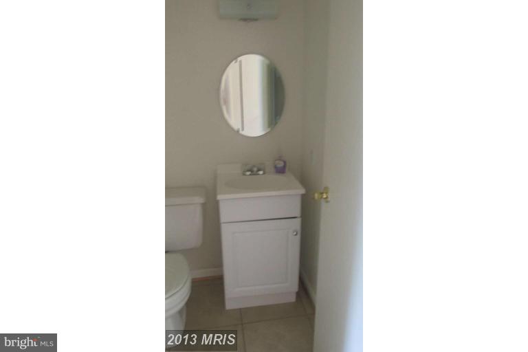 8024 Sandy Spring Road Laurel, MD 20707 - Photo 8 of 21 a bathroom with a sink and a mirror