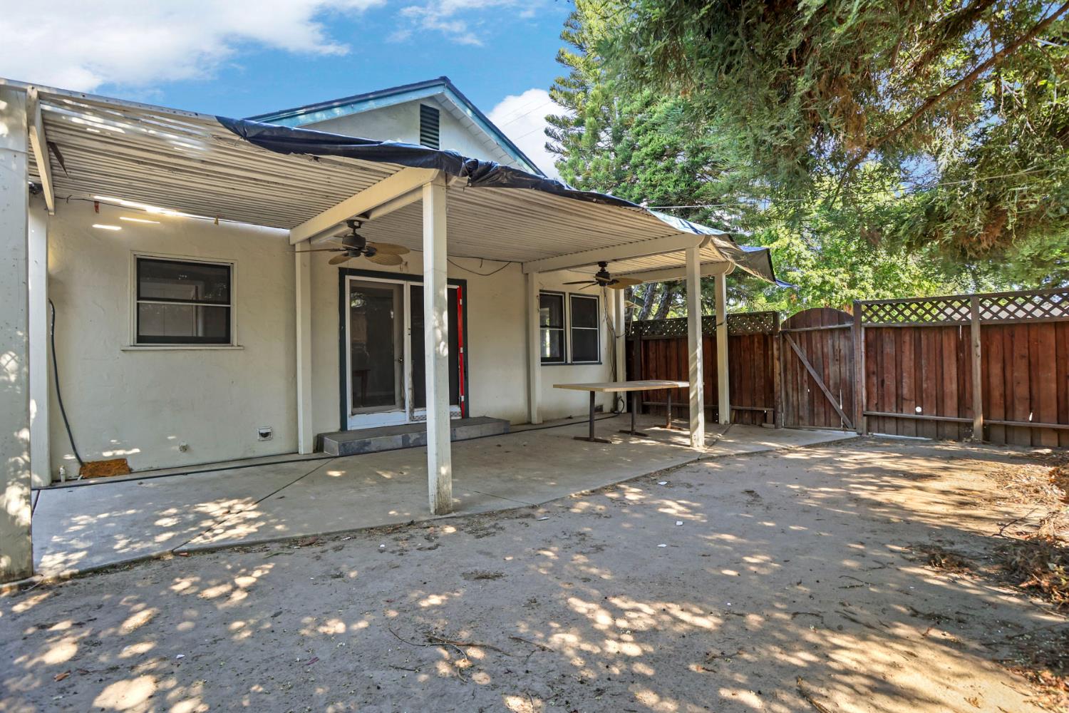 916 Elm Avenue Modesto, CA 95351 - Photo 33 of 52 Spacious covered rear patio provides shaded outdoor living area and functional space between the dwelling and yard.