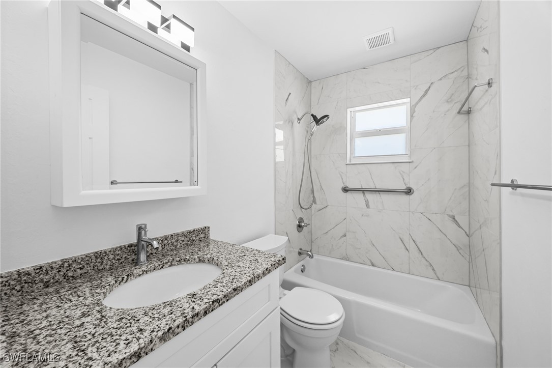 601 Periwinkle Way, Unit D1 Sanibel, FL 33957 - Photo 11 of 25 a bathroom with a granite countertop sink toilet and shower