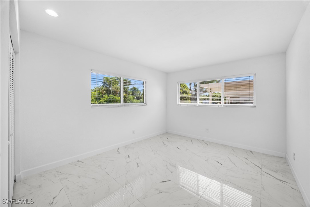 601 Periwinkle Way, Unit D1 Sanibel, FL 33957 - Photo 14 of 25 an empty room with windows