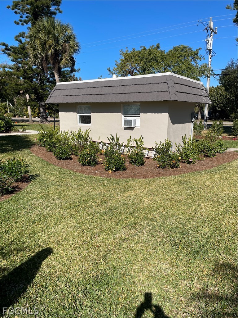 601 Periwinkle Way, Unit D1 Sanibel, FL 33957 - Photo 19 of 25 a front view of a house with garden
