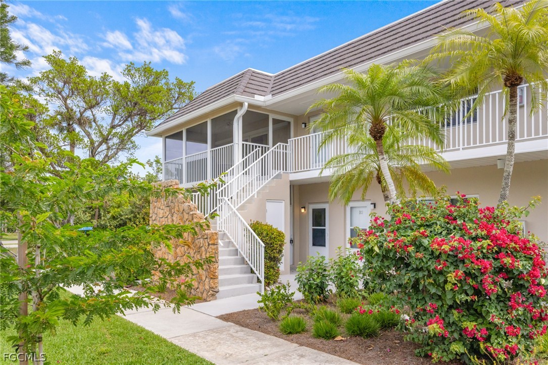 601 Periwinkle Way, Unit D1 Sanibel, FL 33957 - Photo 2 of 25 a front view of a house with a yard
