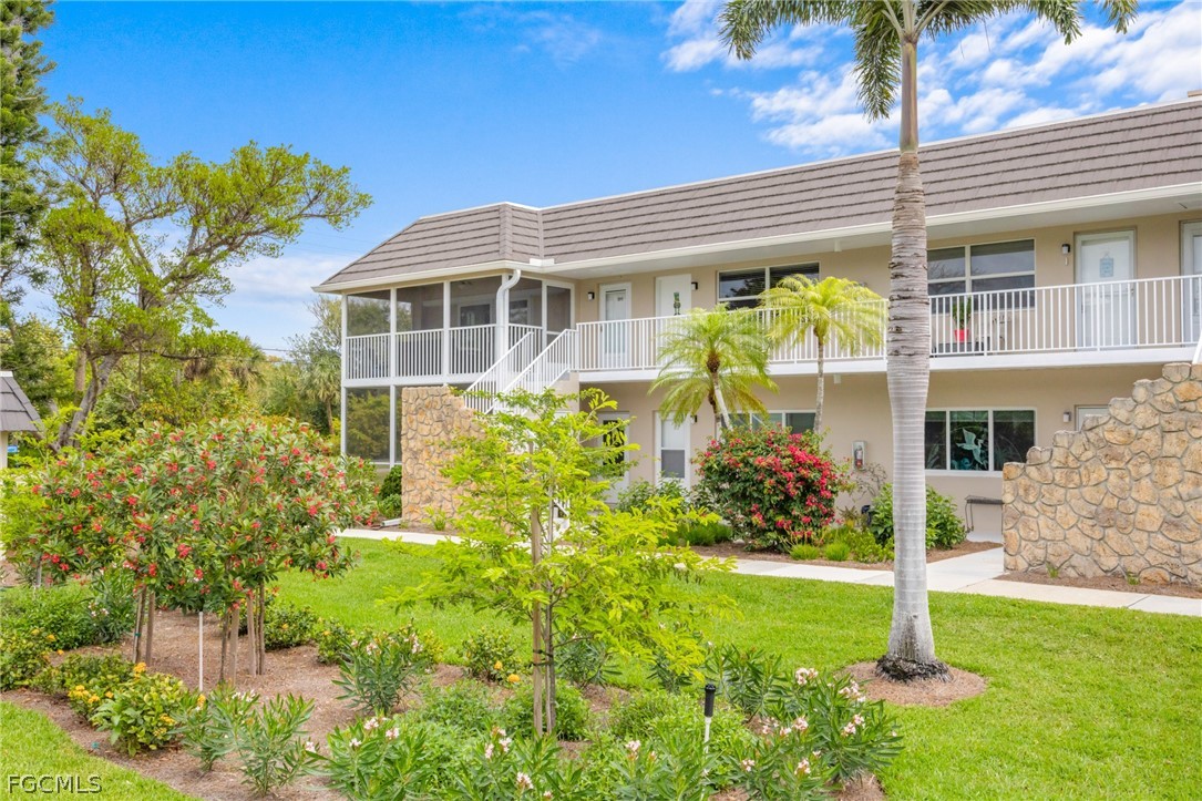601 Periwinkle Way, Unit D1 Sanibel, FL 33957 - Photo 22 of 25 a front view of a house with a yard