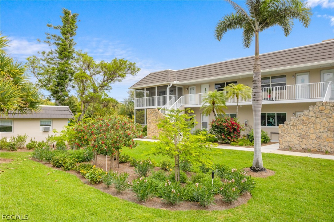 601 Periwinkle Way, Unit D1 Sanibel, FL 33957 - Photo 23 of 25 a front view of a house with a yard