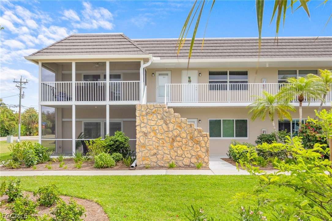 601 Periwinkle Way, Unit D1 Sanibel, FL 33957 - Photo 25 of 25 a front view of a house with a yard
