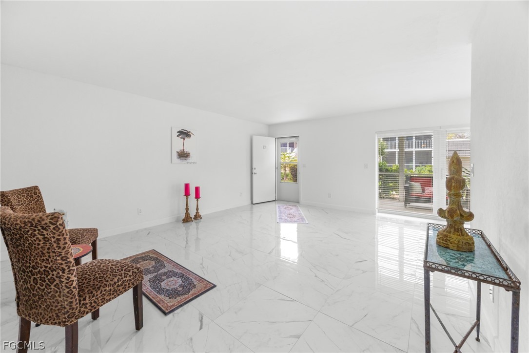 601 Periwinkle Way, Unit D1 Sanibel, FL 33957 - Photo 4 of 25 a living room with furniture and wooden floor