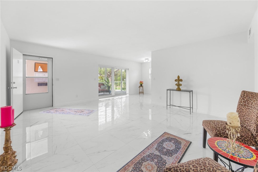 601 Periwinkle Way, Unit D1 Sanibel, FL 33957 - Photo 5 of 25 a bedroom with furniture and a window