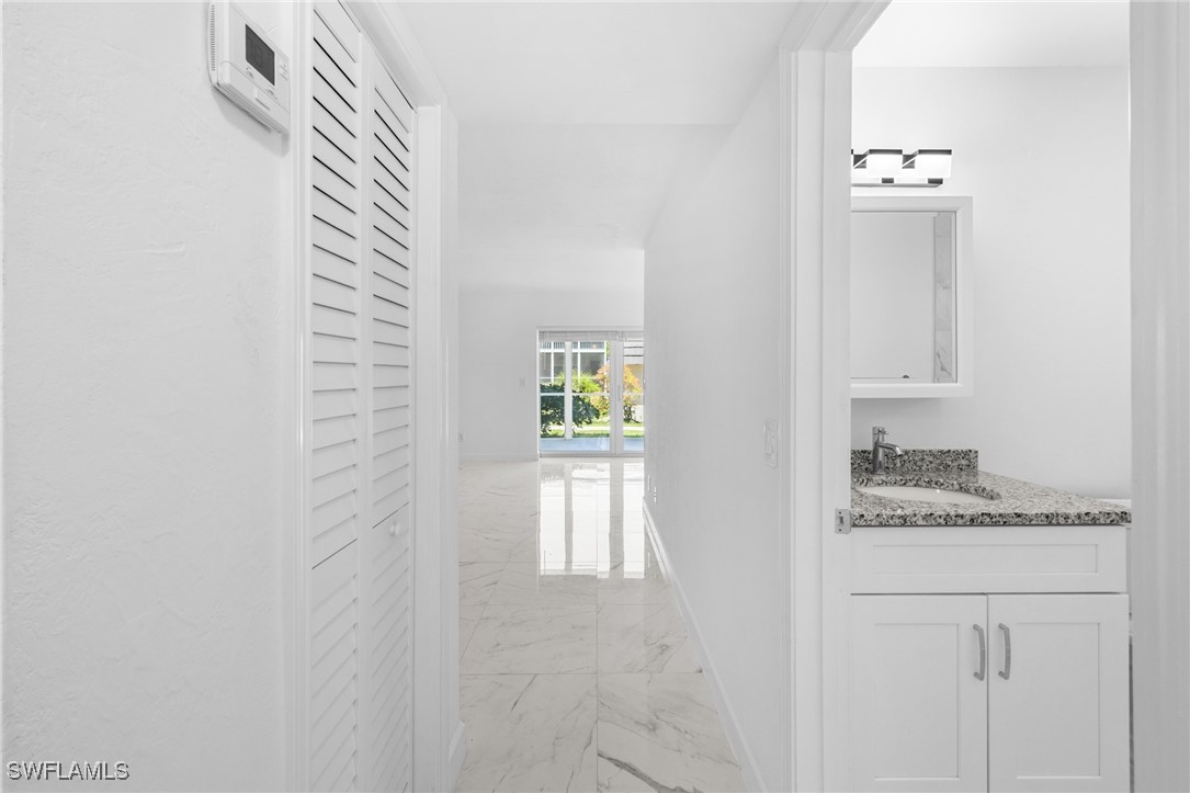 601 Periwinkle Way, Unit D1 Sanibel, FL 33957 - Photo 10 of 25 a bathroom with a granite countertop sink and a mirror