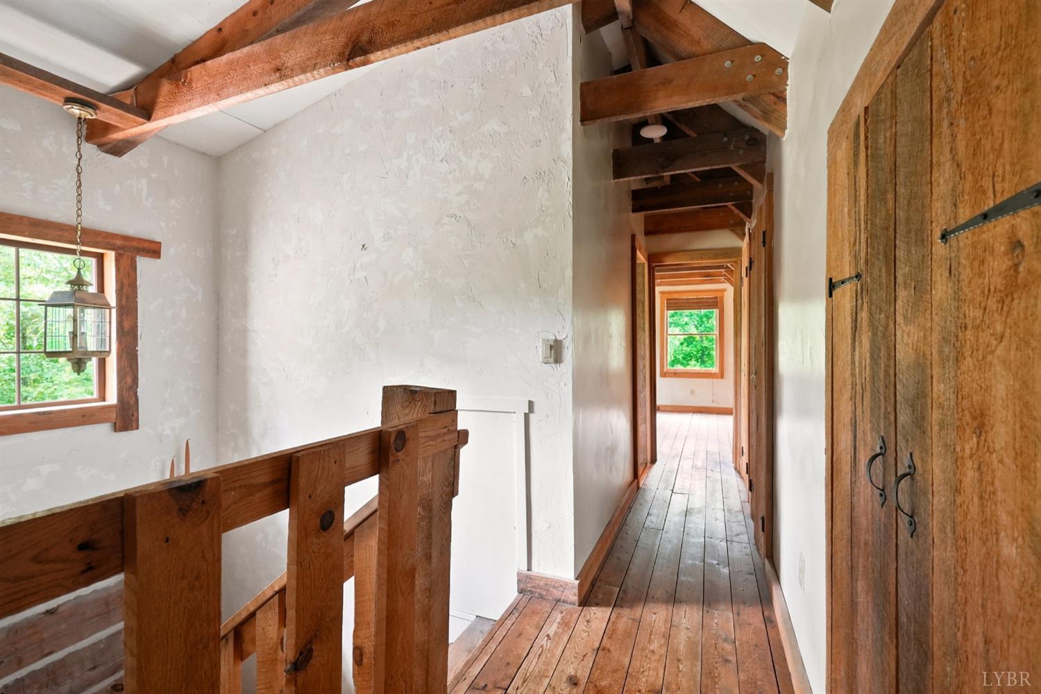 Undisclosed Address Spout Spring, VA 24593 - Photo 45 of 96 a view of a hallway with wooden floor and staircase