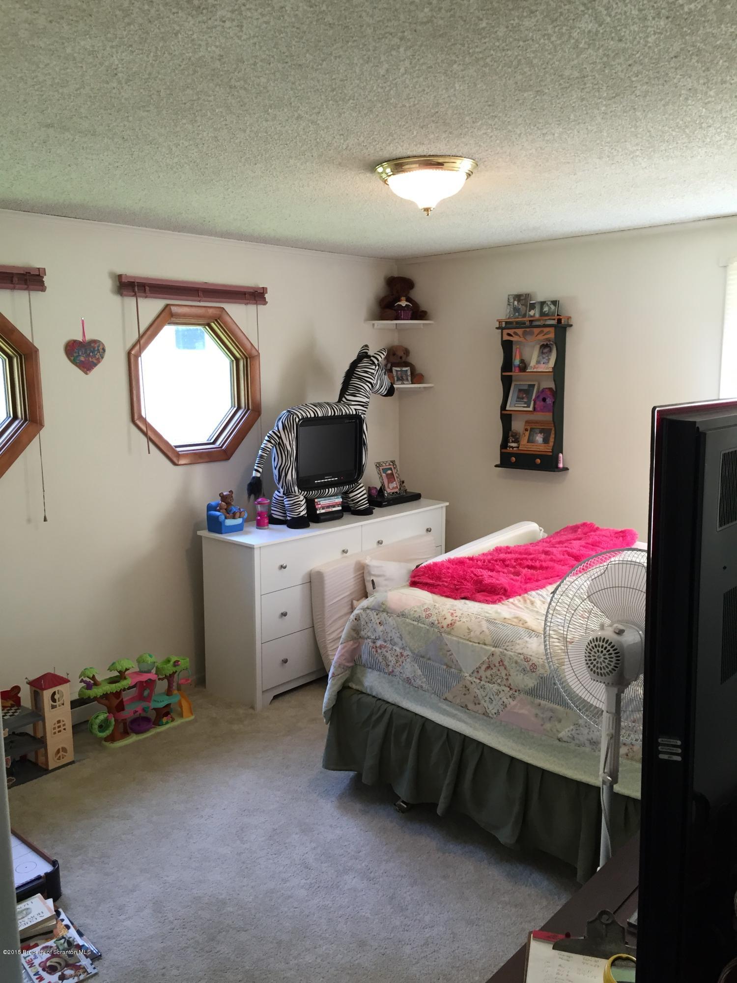 755 Cokely Road Springville, PA 18844 - Photo 8 of 21 a bedroom with a bed and a dresser
