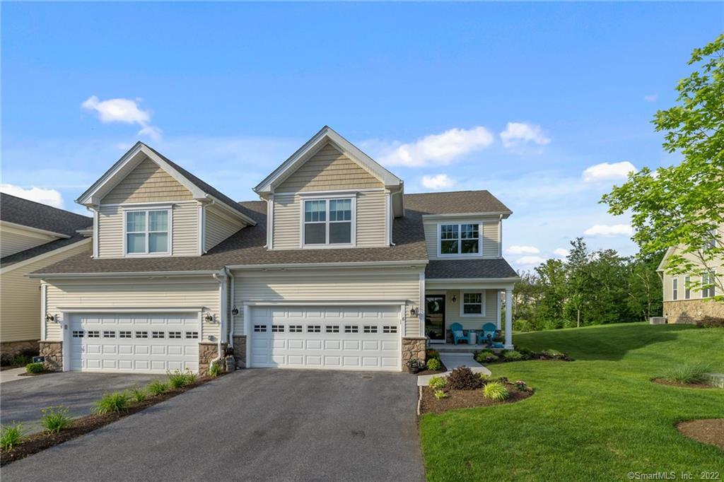 8 Highridge Road, Unit 8 Middlebury, CT 06762 - Photo 1 of 1 a front view of a house with garden and parking