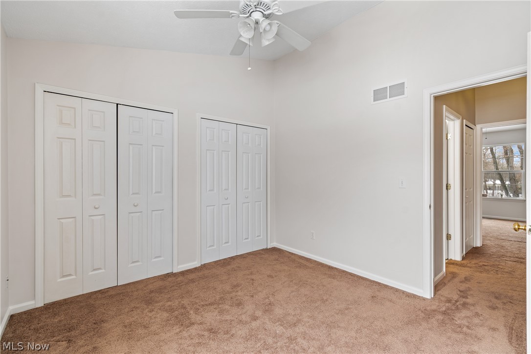 1273 Meadow Run Akron, OH 44321 - Photo 12 of 28 Bedroom #1 with double closets, carpet floors, ceiling fan, and a high ceiling