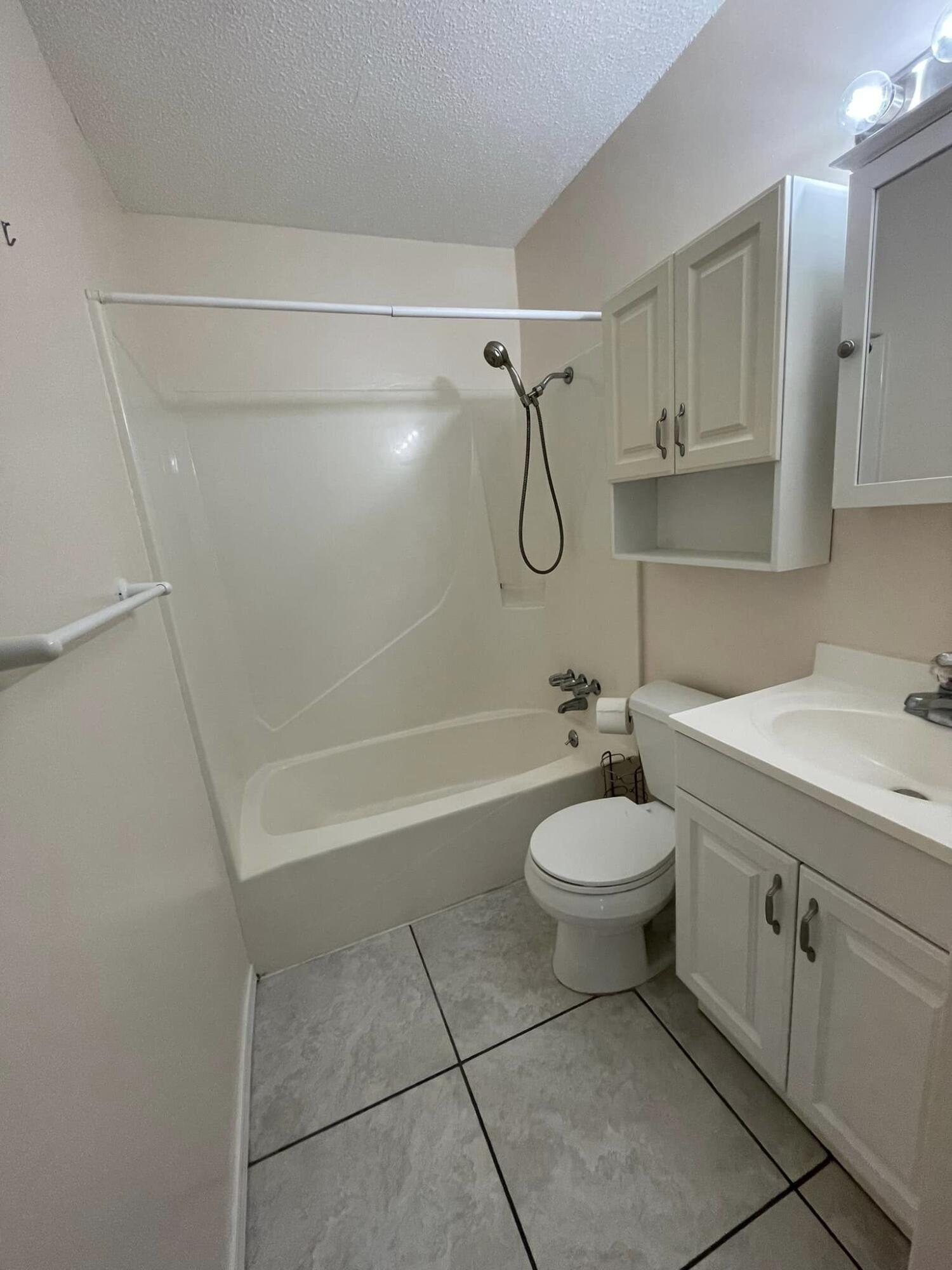 688 Roberts Drive DeFuniak Springs, FL 32433 - Photo 13 of 19 a bathroom with a granite countertop sink a toilet and shower
