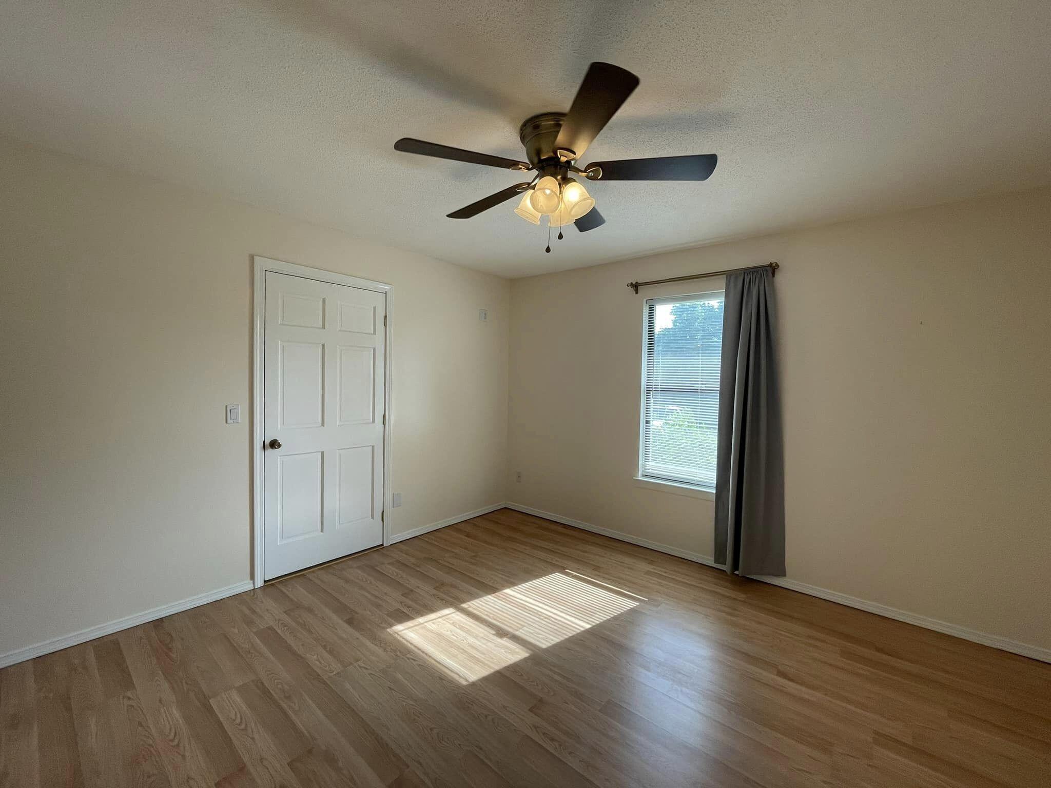688 Roberts Drive DeFuniak Springs, FL 32433 - Photo 8 of 19 a view of empty room with wooden floor and fan