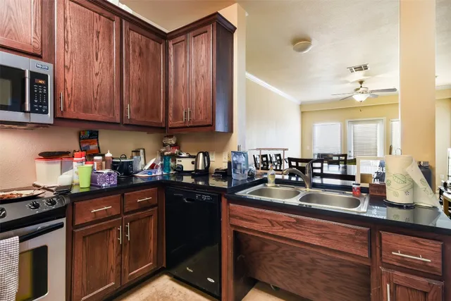 a kitchen with sink cabinets and appliances
