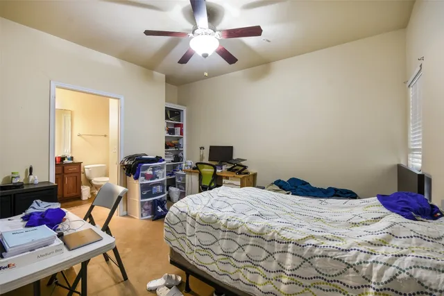 a bedroom that has a bed and a chandelier
