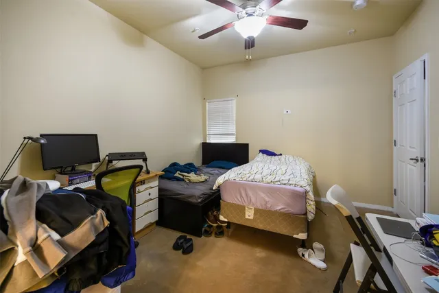 a bedroom with a bed and a desk
