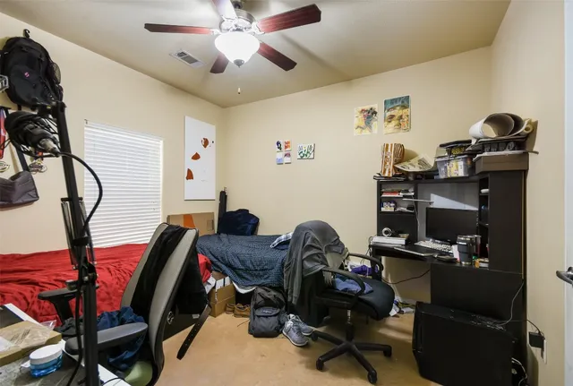 a view of a workspace with furniture and gym equipment