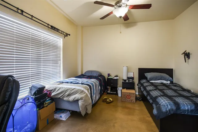 a bedroom with two beds and a chandelier