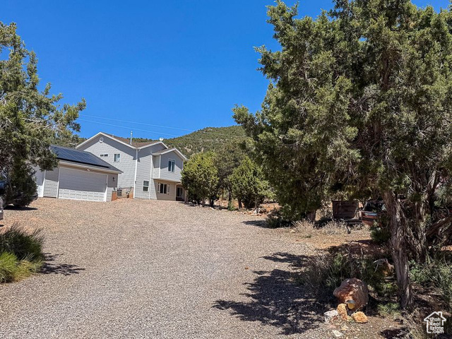 425 East Mule Deer Road Central, UT 84722 - Photo 45 of 72 View of front facade featuring an outbuilding, an attached garage, and gravel driveway