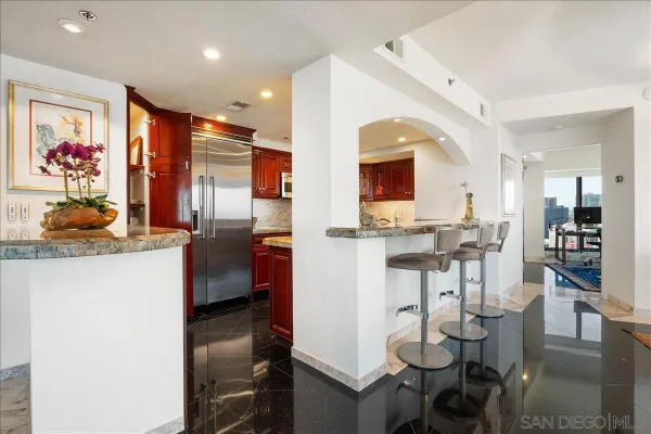a living room with furniture and kitchen view