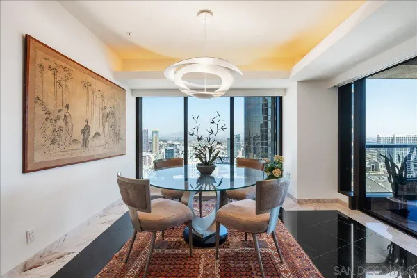 a view of a dining room with furniture large window and wooden floor