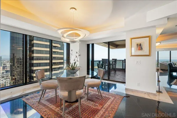 a living room with furniture and a floor to ceiling window