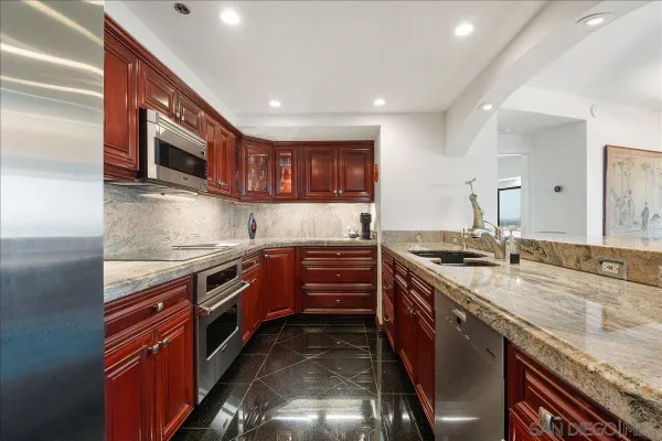 a kitchen with stainless steel appliances granite countertop a stove and a sink