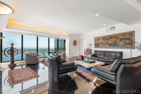 a living room with furniture and a floor to ceiling window