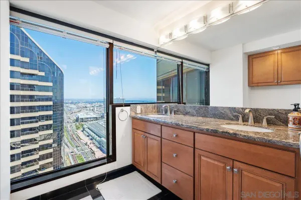 a bathroom with a granite countertop sink mirror and vanity