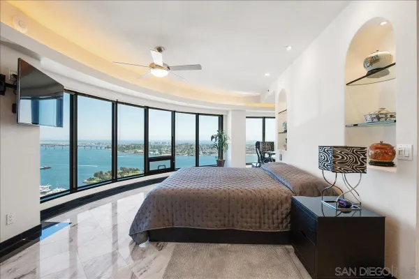 a bedroom with a large bed and a large window