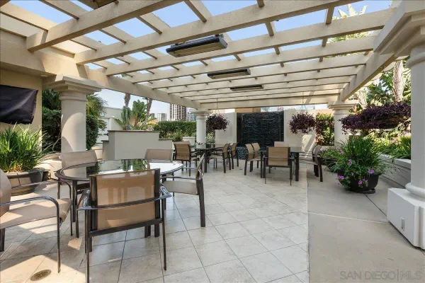 a view of a patio with table and chairs potted plants and plants