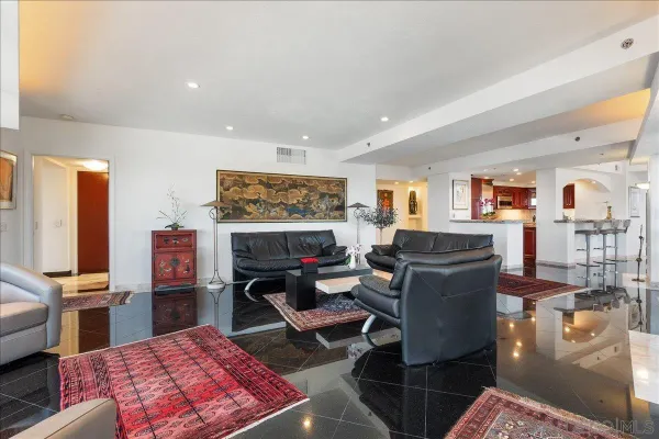 a living room with furniture a rug and a flat screen tv