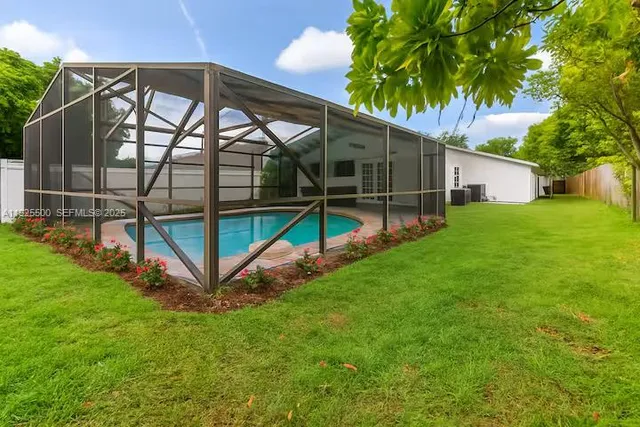 a view of a backyard with a garden and deck