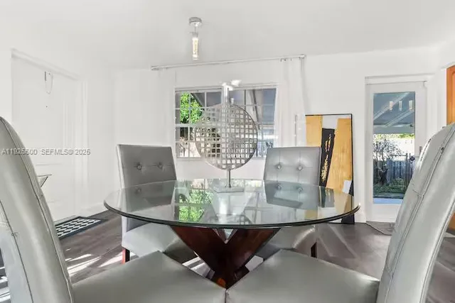 a view of a dining room with furniture and wooden floor
