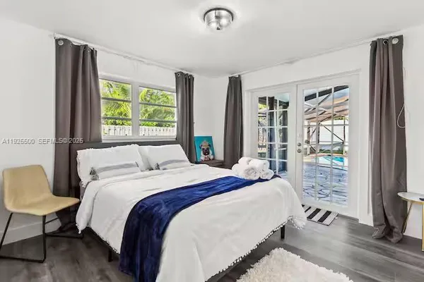 a bed sitting in a bedroom next to a window