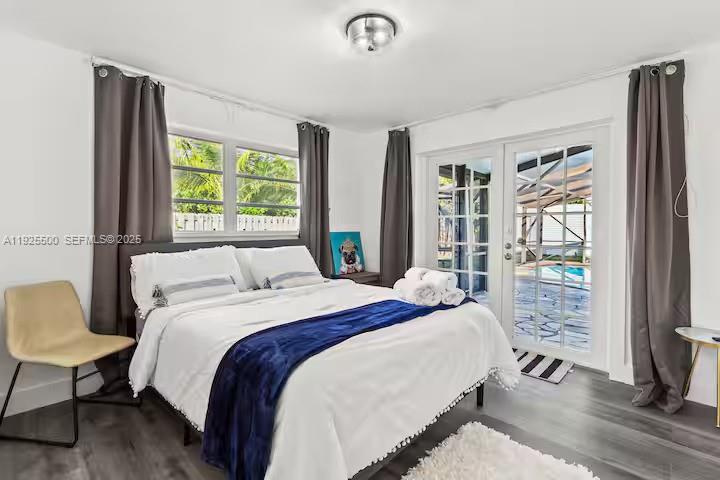 909 Northeast 7th Street Pompano Beach, FL 33060 - Photo 4 of 37 a bed sitting in a bedroom next to a window