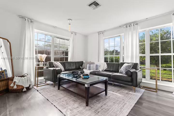 909 Northeast 7th Street Pompano Beach, FL 33060 - Photo 5 of 37 a living room with furniture and a floor to ceiling window
