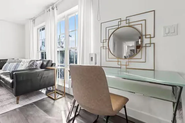 a living room with furniture and a mirror