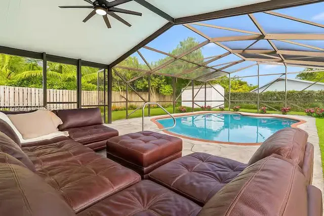 a view of a livingroom with furniture and a floor to ceiling window