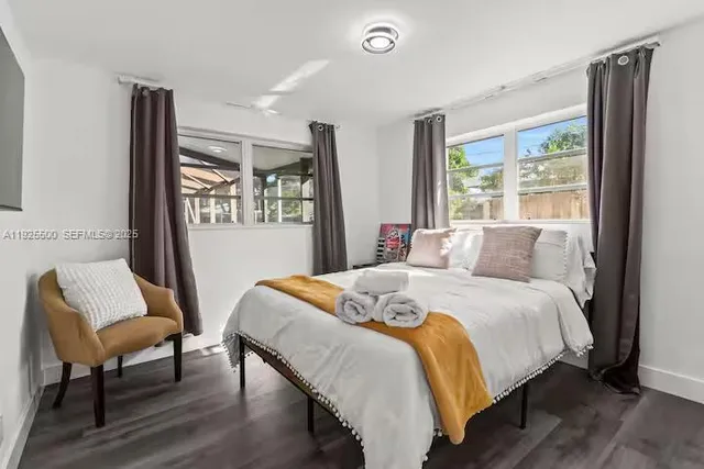 a bed sitting in a bedroom next to a window