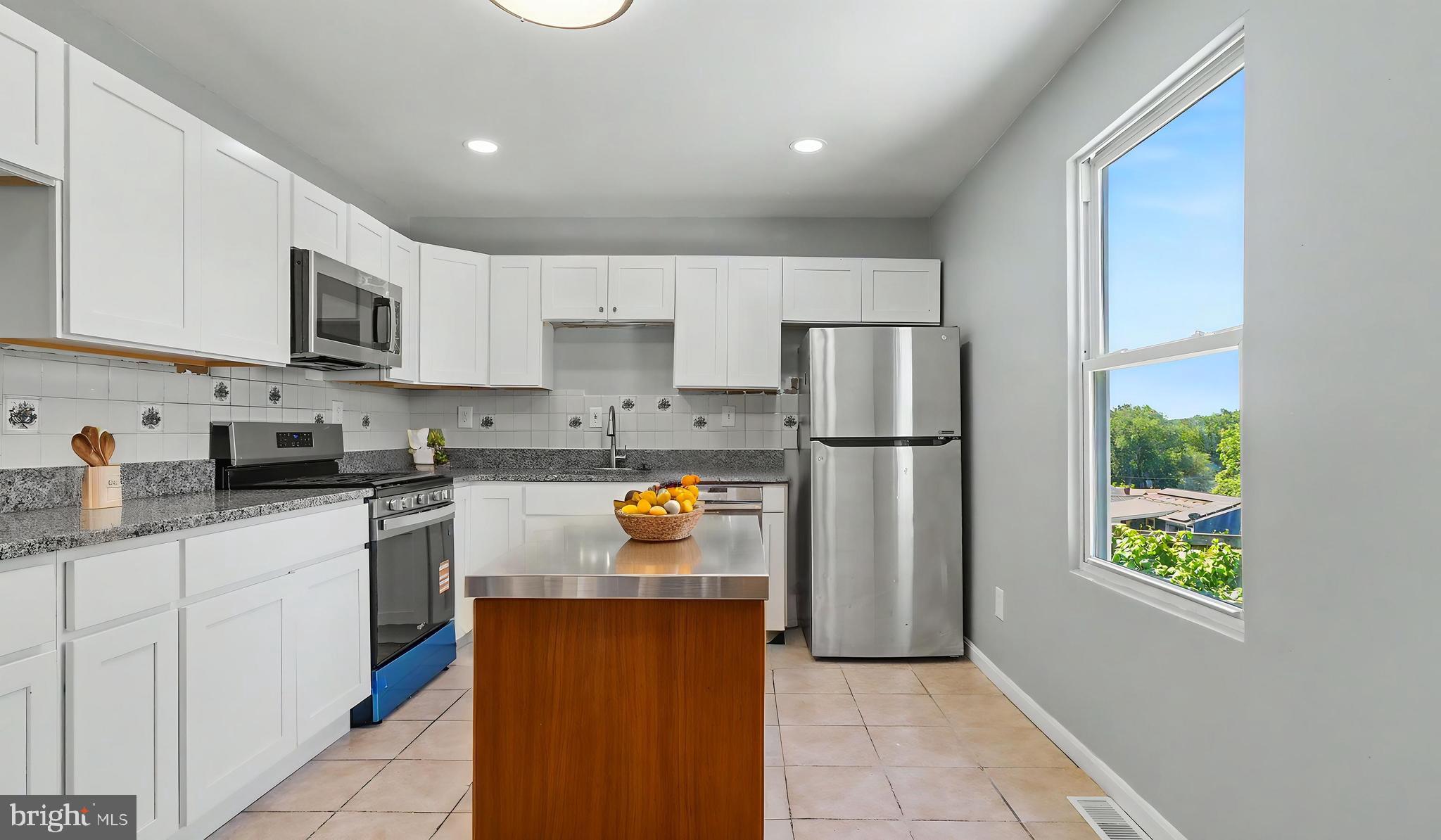 4203 Shell Street Capitol Heights, MD 20743 - Photo 44 of 47 a kitchen with stainless steel appliances granite countertop a refrigerator sink and stove