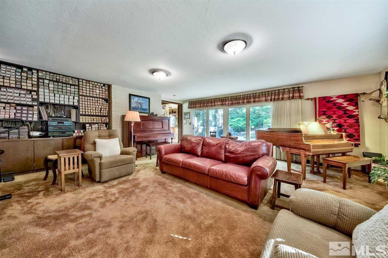 3550 Lamay Lane Reno, NV 89511 - Photo 14 of 25 a living room with furniture a fireplace and a large window