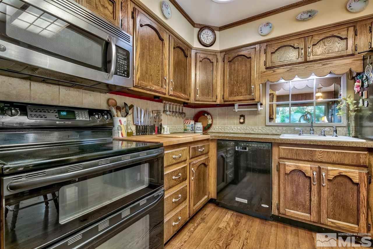 3550 Lamay Lane Reno, NV 89511 - Photo 18 of 25 a kitchen with stainless steel appliances granite countertop a stove and a sink