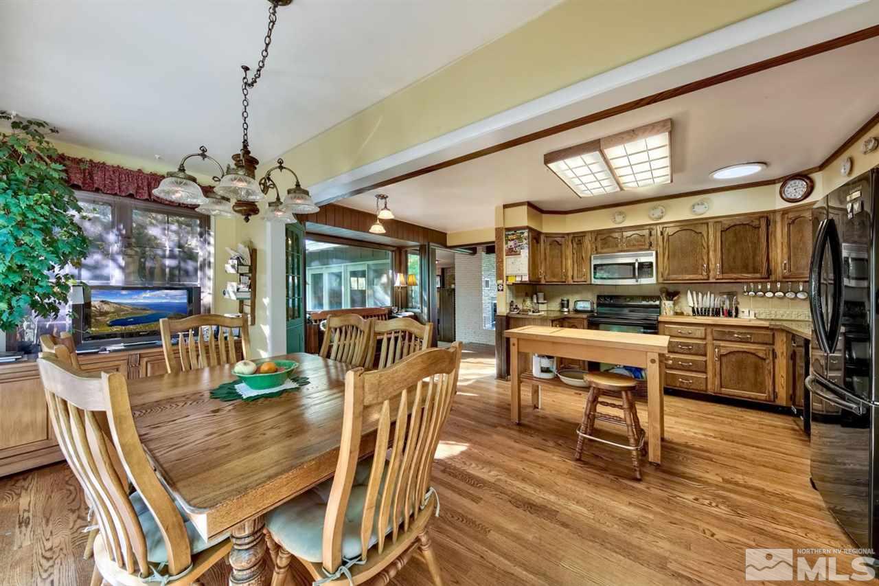 3550 Lamay Lane Reno, NV 89511 - Photo 19 of 25 a dining room with furniture a chandelier and wooden floor