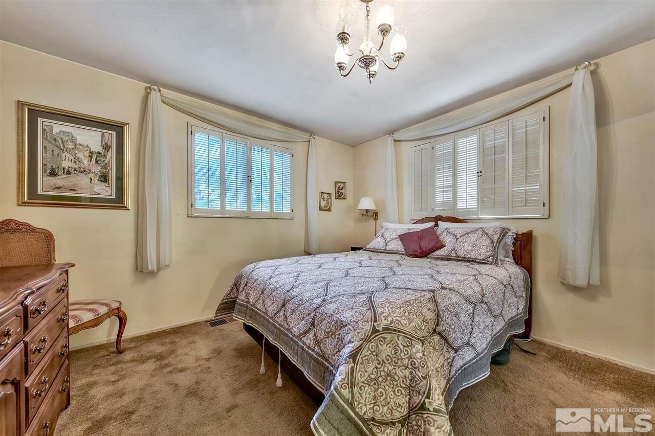 3550 Lamay Lane Reno, NV 89511 - Photo 24 of 25 a bedroom with a bed and a table chair