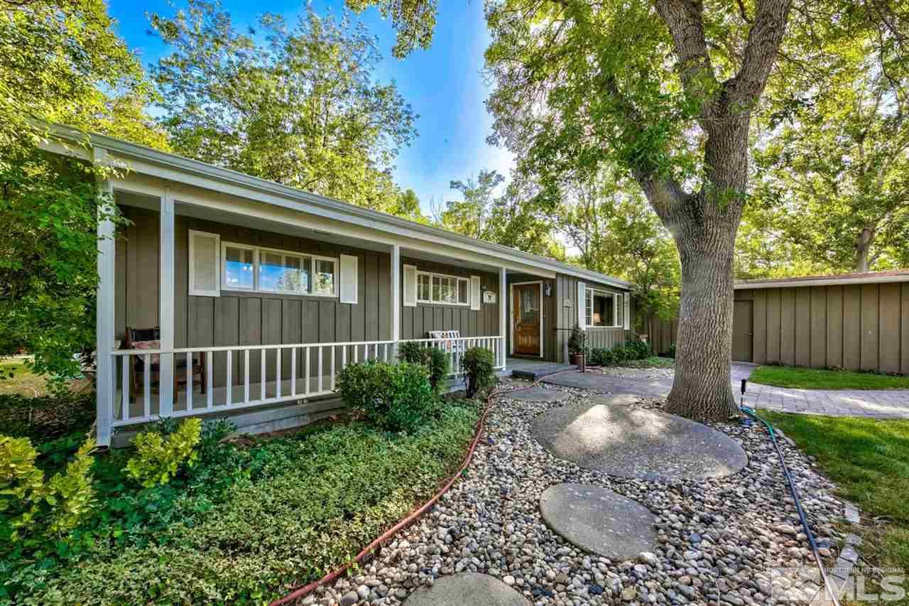 3550 Lamay Lane Reno, NV 89511 - Photo 6 of 25 a view of a backyard with table and chairs and wooden fence