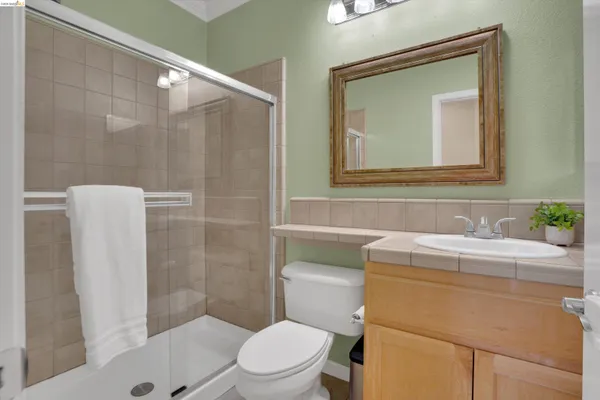 a bathroom with a toilet a sink and a mirror