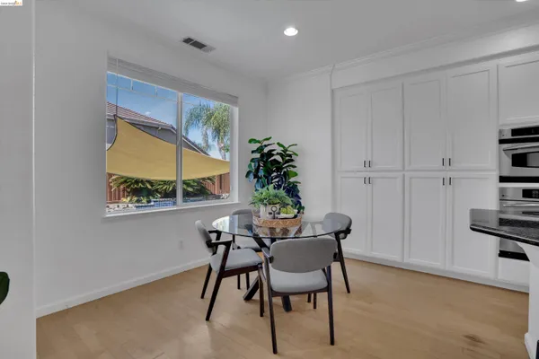 a view of a dining room with furniture and a potted plant